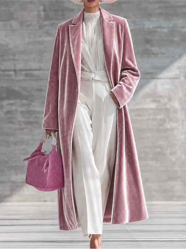 Woman wearing a pink velvet maxi coat with notched lapel