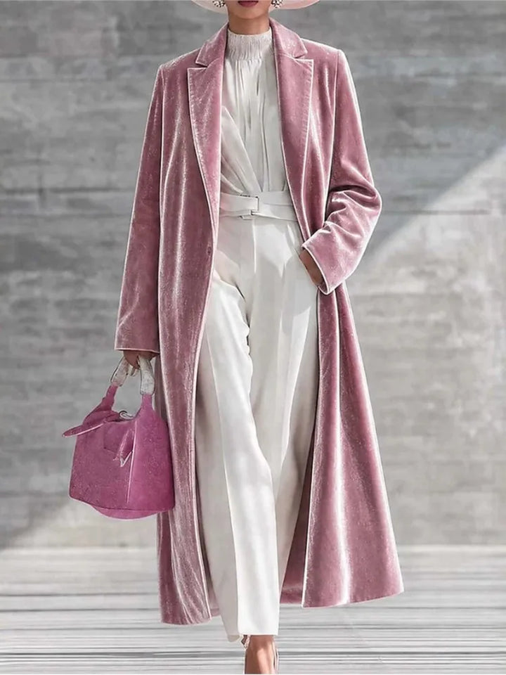 Woman wearing a pink velvet maxi coat with notched lapel