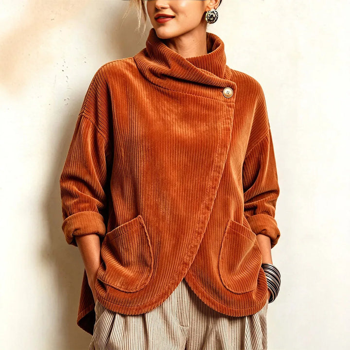 Woman wearing orange ribbed corduroy jacket with asymmetric button collar