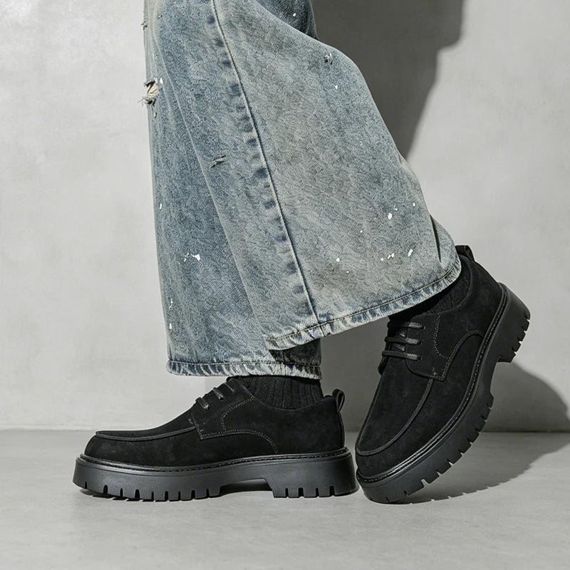 Man wearing black suede oxford shoes with wide leg jeans