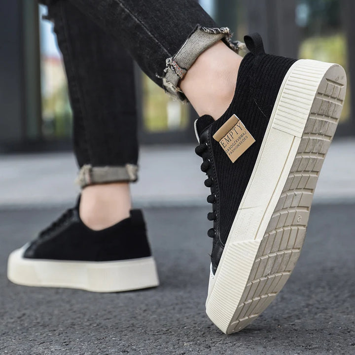 Black sneaker close side view on foot