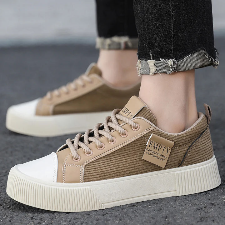 Khaki sneaker worn on foot with jeans
