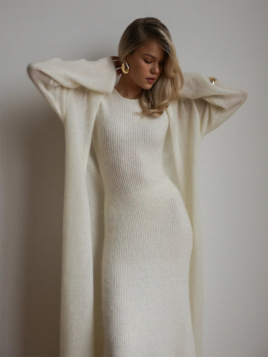 Woman wearing white ribbed knit sweater dress with long duster layer
