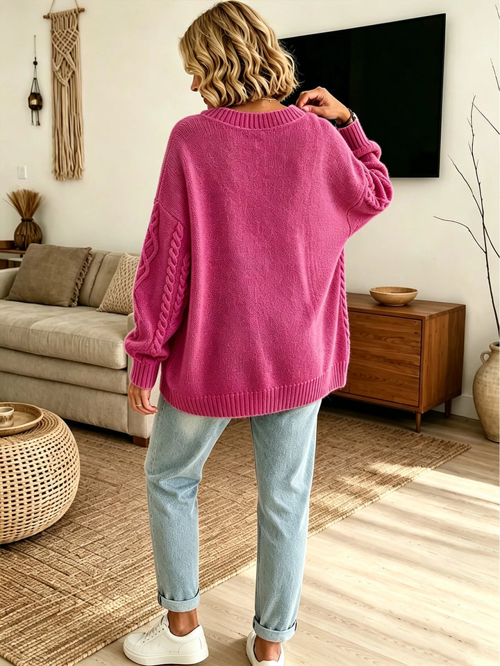 Back view of rose pink cardigan with cable knit sleeves