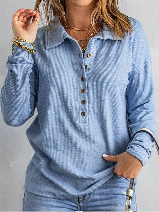 Woman wearing sky blue ribbed knit henley top with turn-down collar