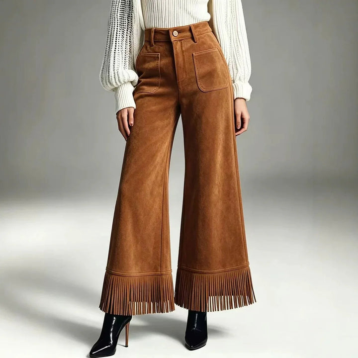 Woman wearing brown suede-look flare pants with fringe hem, front view