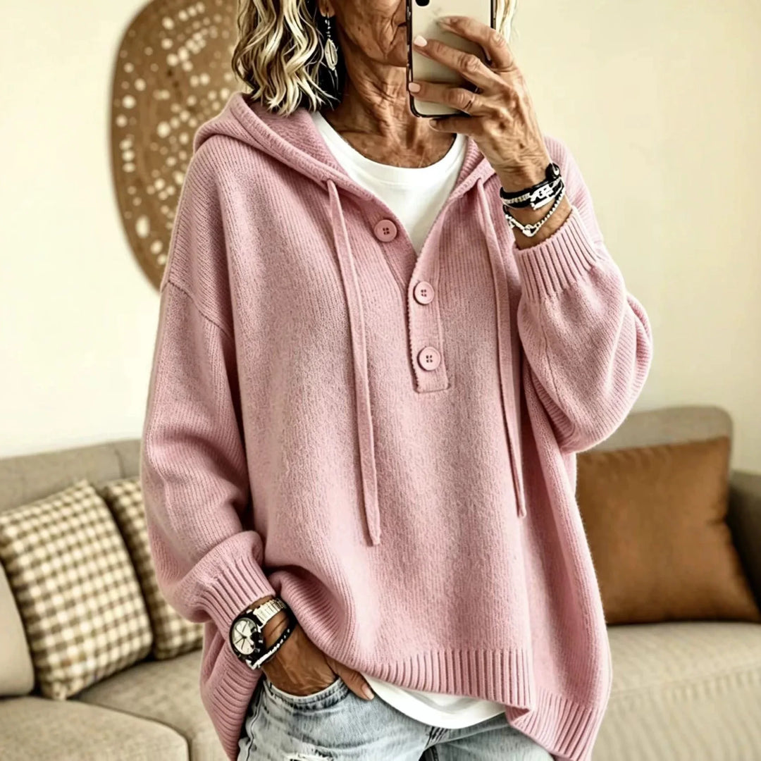 Woman wearing pink button placket hooded sweater