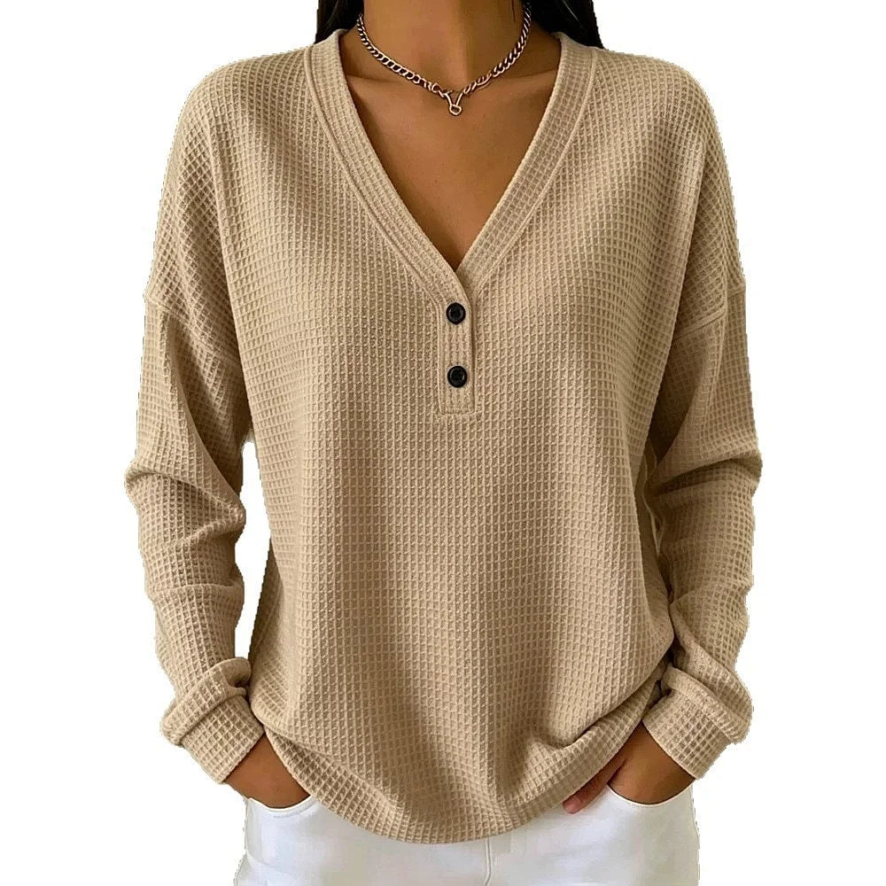 Woman wearing khaki waffle knit V-neck henley top with button placket