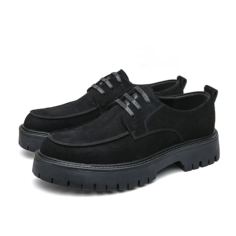 Pair of black suede platform oxford shoes on white background