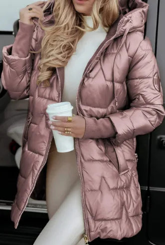 Woman wearing pink quilted mid length puffer jacket with hood