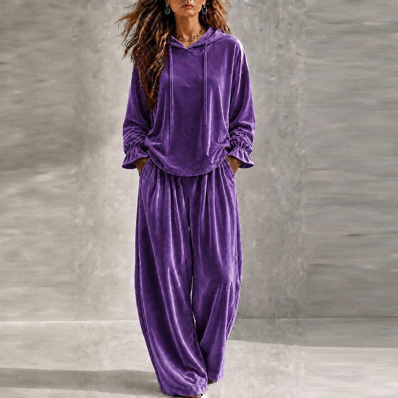 Woman wearing purple velvet hooded tracksuit with wide leg pants