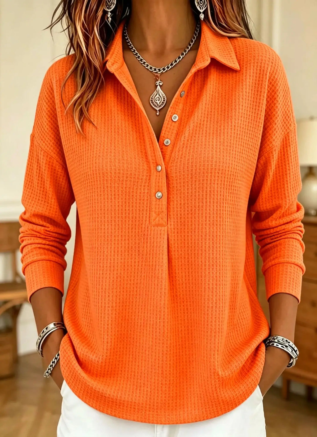 Orange waffle knit polo shirt with button placket, front view