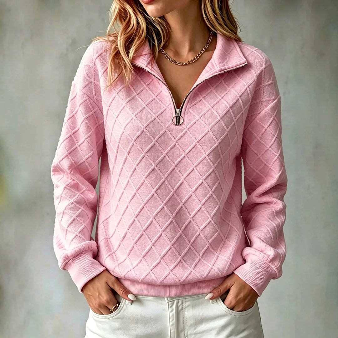 Woman wearing pink diamond textured quarter zip pullover