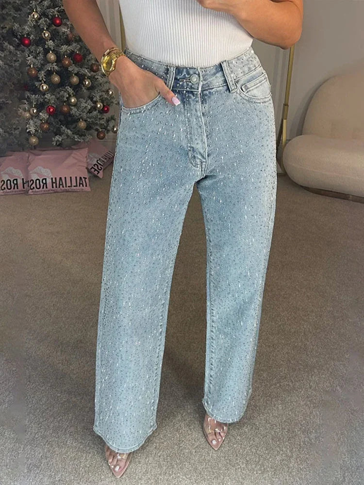 Woman wearing light blue rhinestone embellished wide leg jeans, front view
