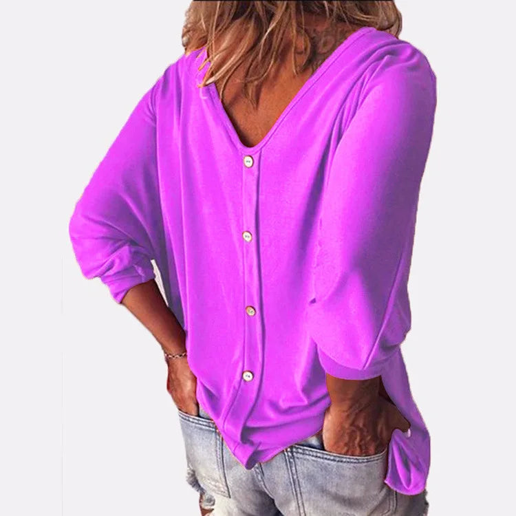 Woman wearing purple top with back button detail, close view