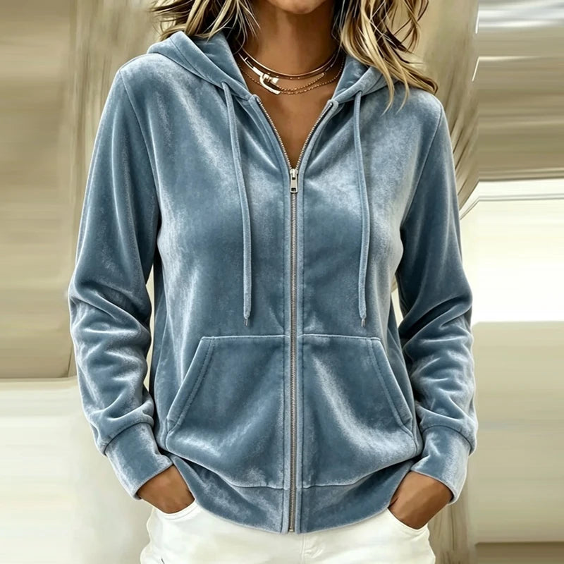 Woman wearing dusty blue velour zip-up hoodie