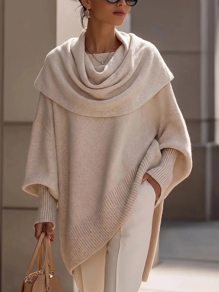 Woman wearing apricot draped scarf collar poncho sweater, front view