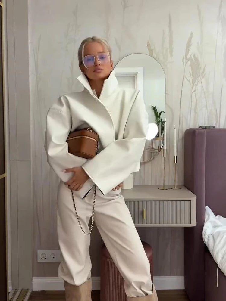White faux leather jacket paired with matching trousers