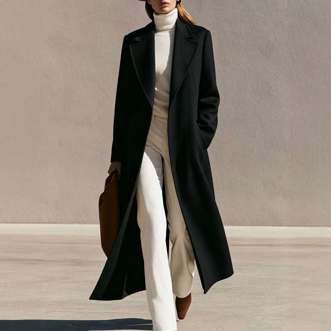 Woman wearing long black wool-blend coat with notched lapel walking outdoors