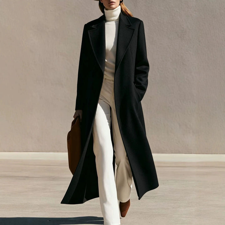 Woman wearing long black wool-blend coat with notched lapel walking outdoors