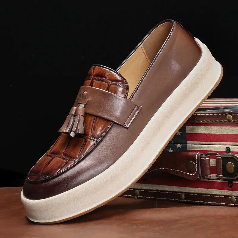 Brown tasseled loafer with croc-embossed toe and thick platform sole, side view
