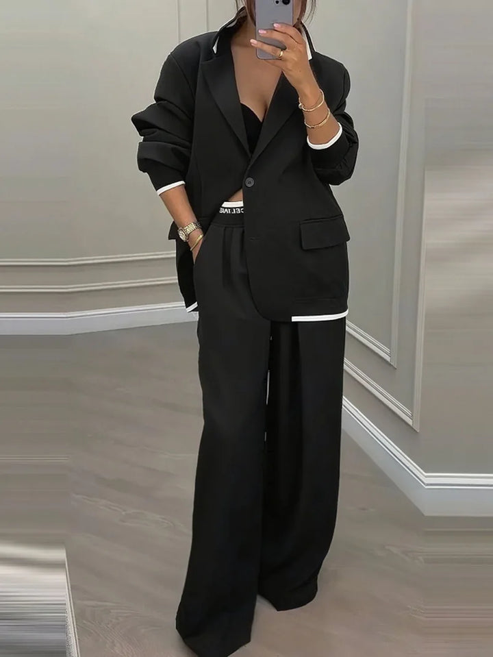 Black contrast trim blazer and wide leg trouser suit, front view