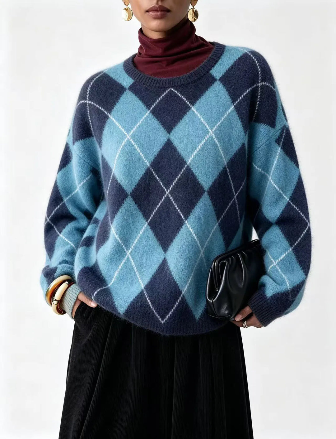 Woman wearing blue and navy argyle knit sweater with burgundy turtleneck