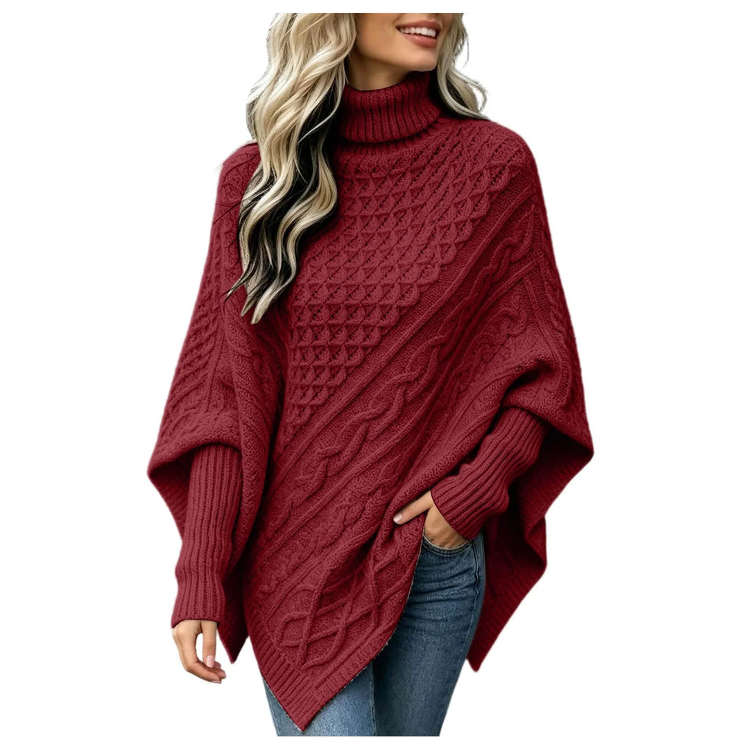 Woman wearing wine red cable knit asymmetric poncho sweater with turtleneck