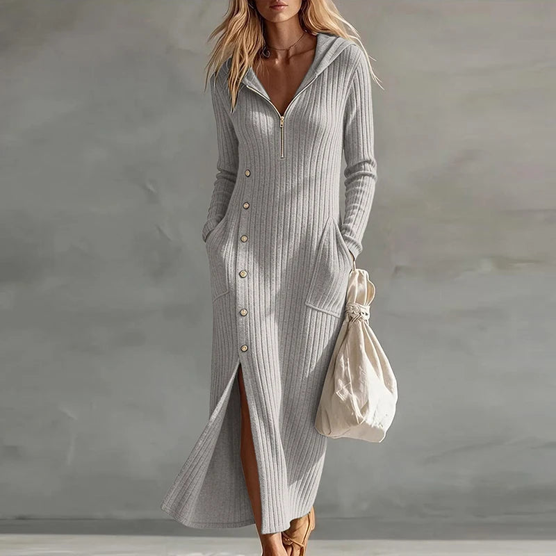 Woman wearing gray hooded ribbed knit maxi dress with half zip front and slit hem