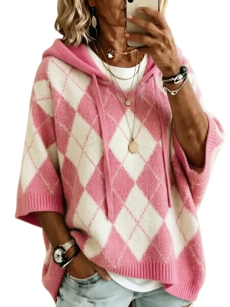 Woman wearing pink argyle hooded knit sweater, front view