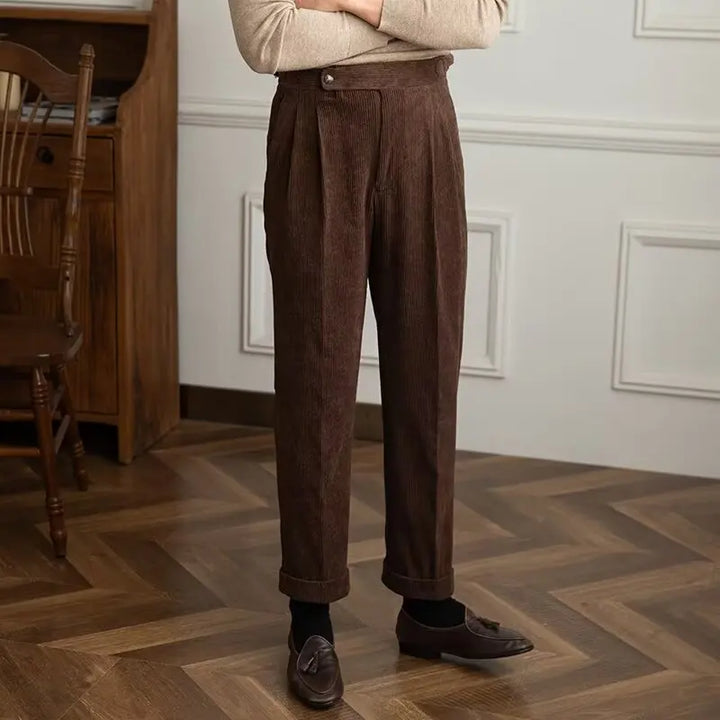 Man wearing coffee brown corduroy trousers with cuffed hem, front view