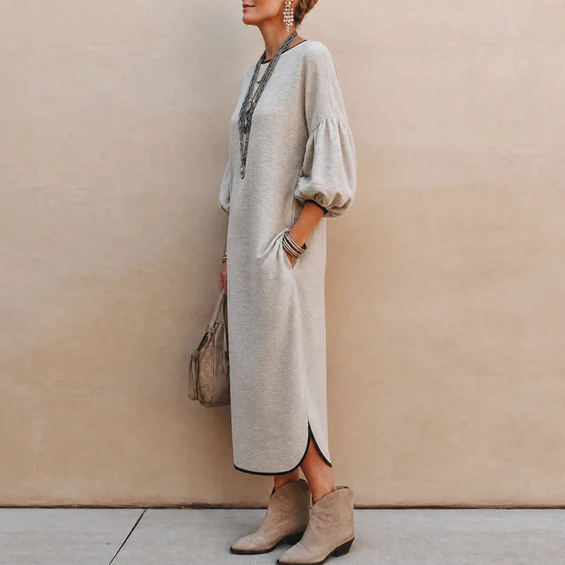 Side view of apricot knit maxi dress with lantern sleeves and side slit