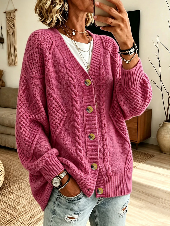Woman wearing pink cable knit button front cardigan with V-neck