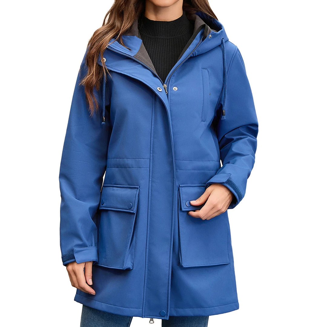 Woman wearing blue hooded rain jacket, front view