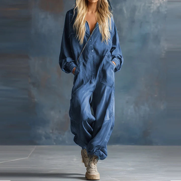 Blue denim hooded jumpsuit with patch pockets, walking pose