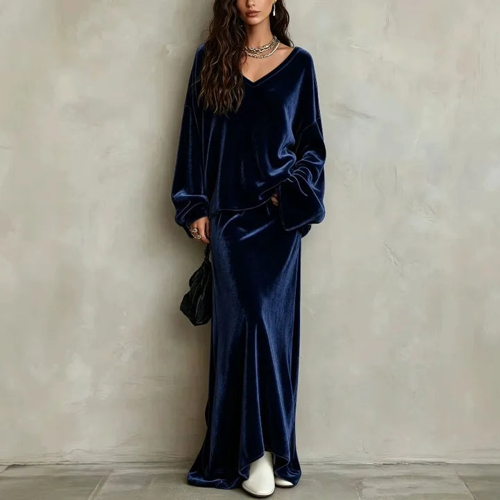 Woman wearing dark blue velvet V neck pullover and matching maxi skirt set