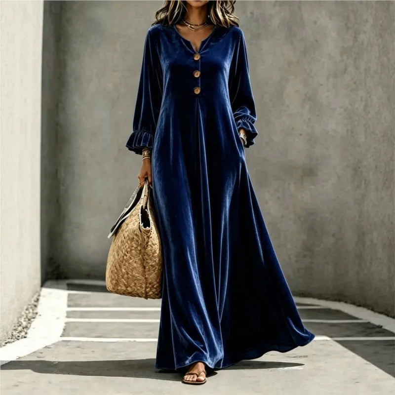 Woman wearing deep blue velvet maxi dress, front view