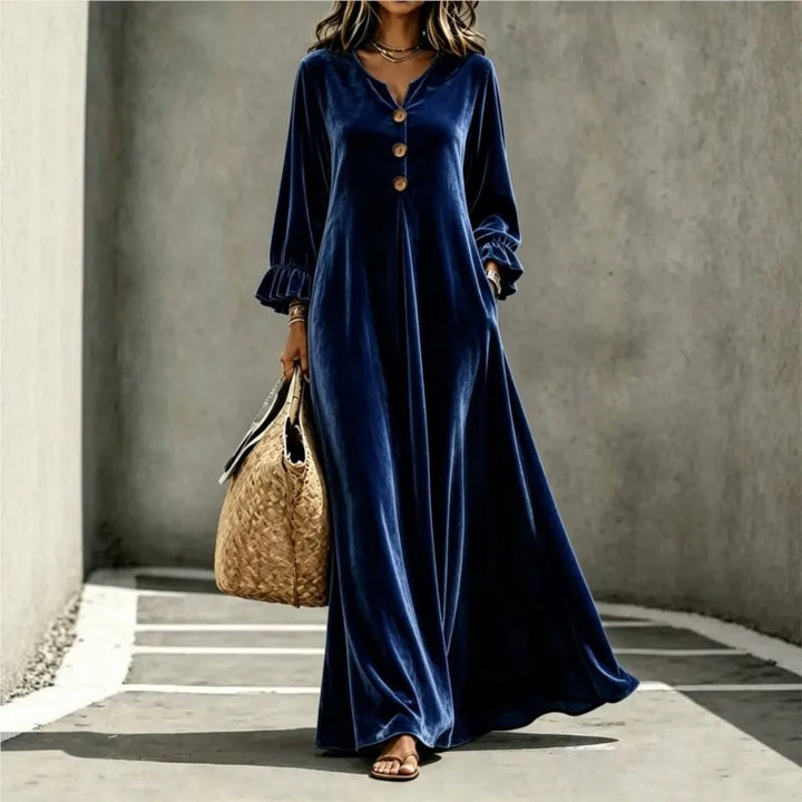 Woman wearing deep blue velvet maxi dress, front view
