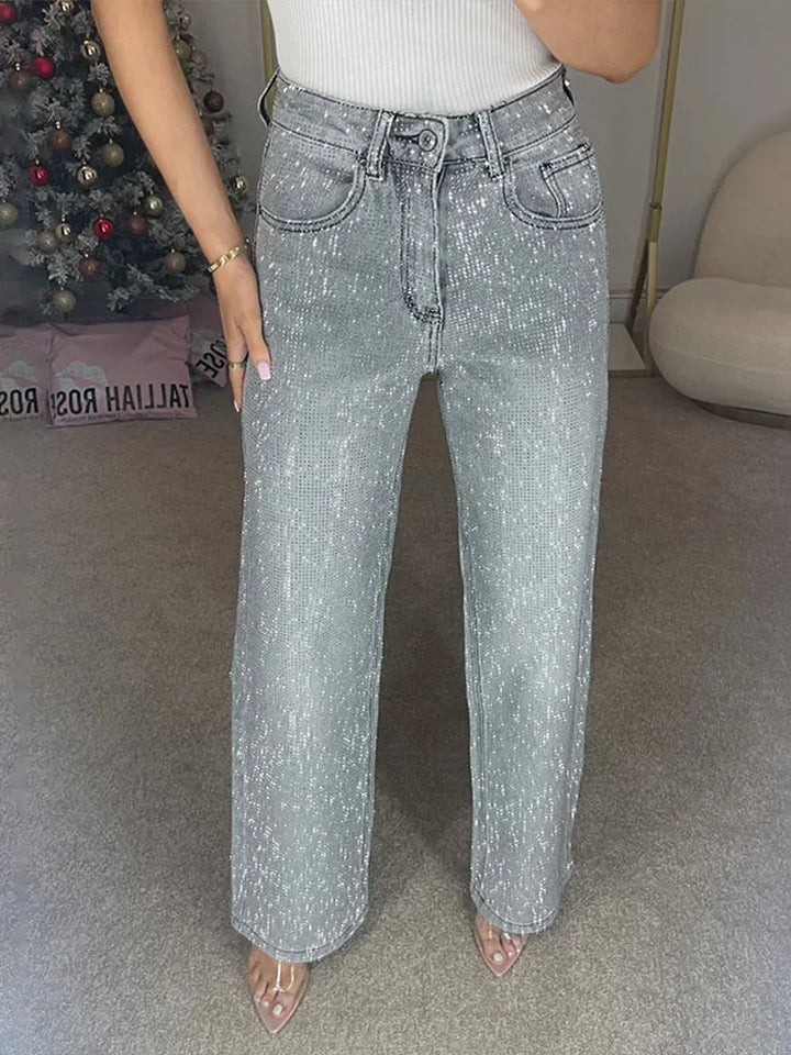 Woman wearing light gray rhinestone embellished wide leg jeans, front view