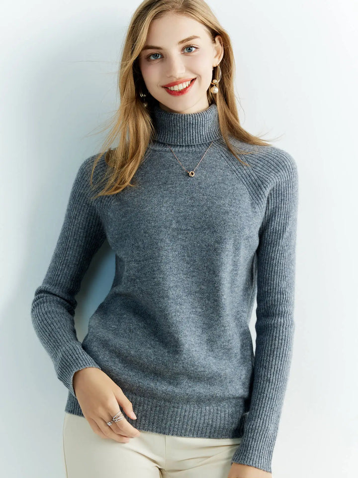 Smiling woman wearing grey turtleneck sweater