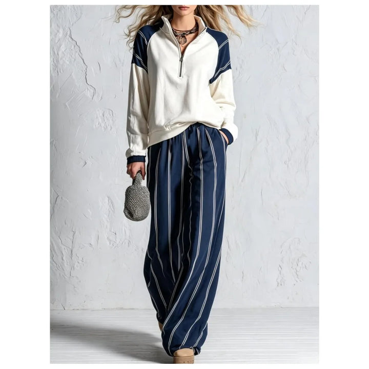 Woman wearing navy blue striped wide leg pants with color block quarter zip pullover