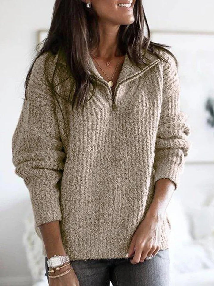 Woman wearing khaki textured knit quarter-zip sweater with stand collar