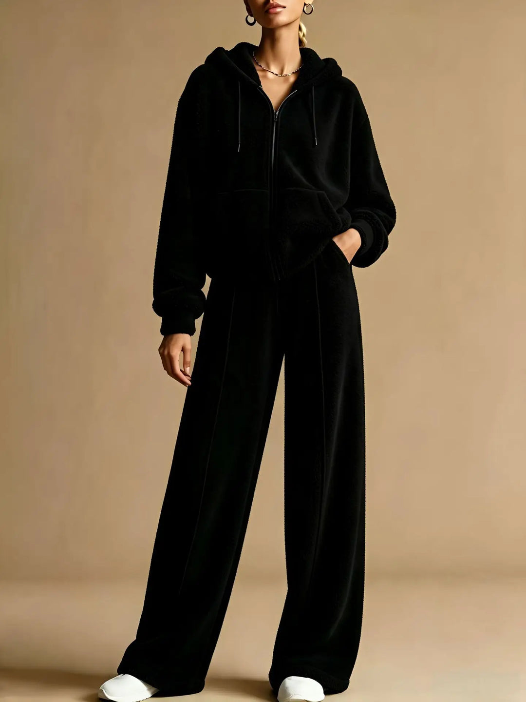 Woman wearing black sherpa zip hoodie and wide leg pants set