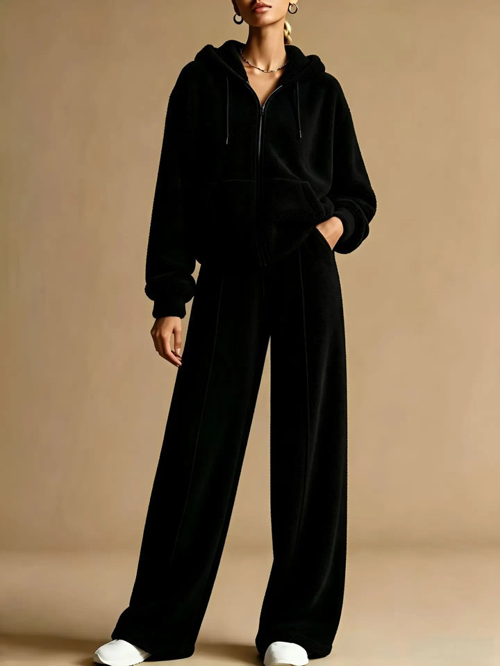 Woman wearing black sherpa zip hoodie and wide leg pants set
