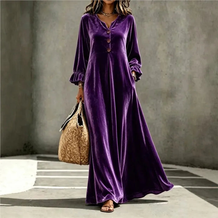 Woman wearing purple velvet maxi dress, front view