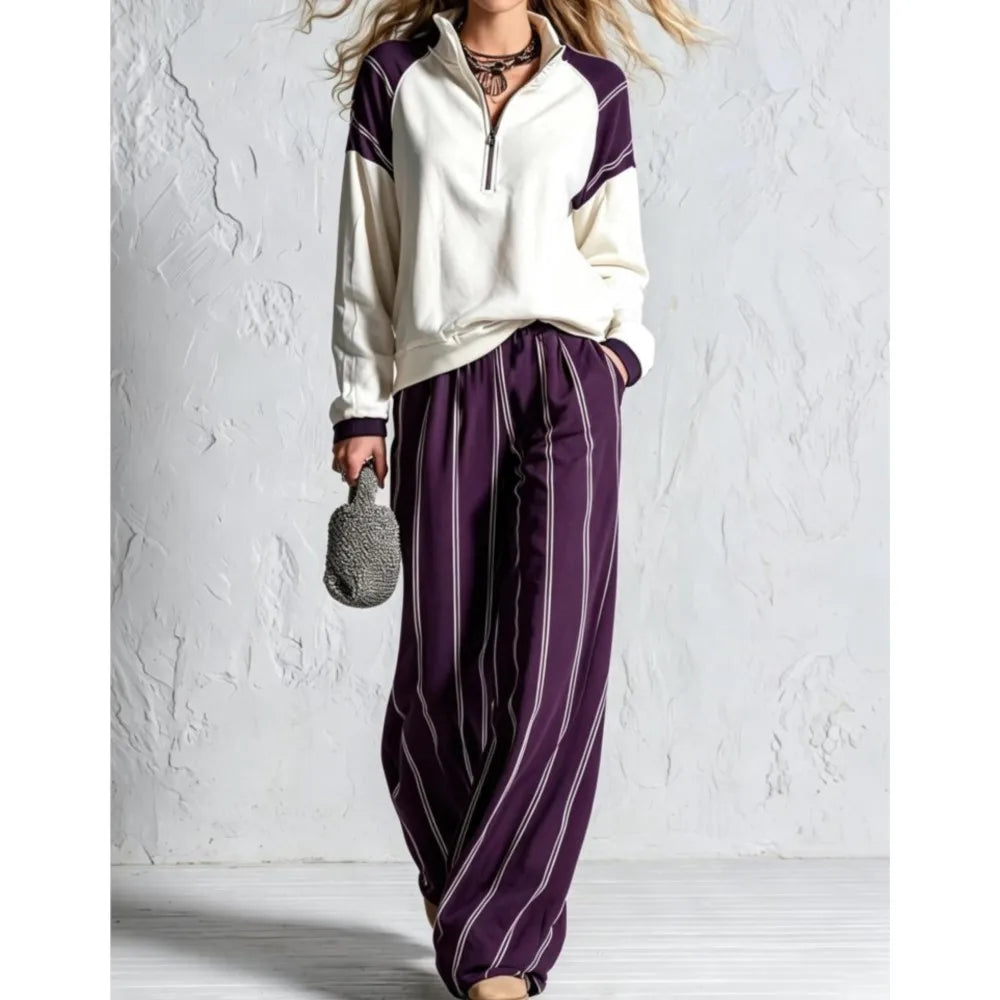 Woman wearing purple striped wide leg pants with cream color block pullover