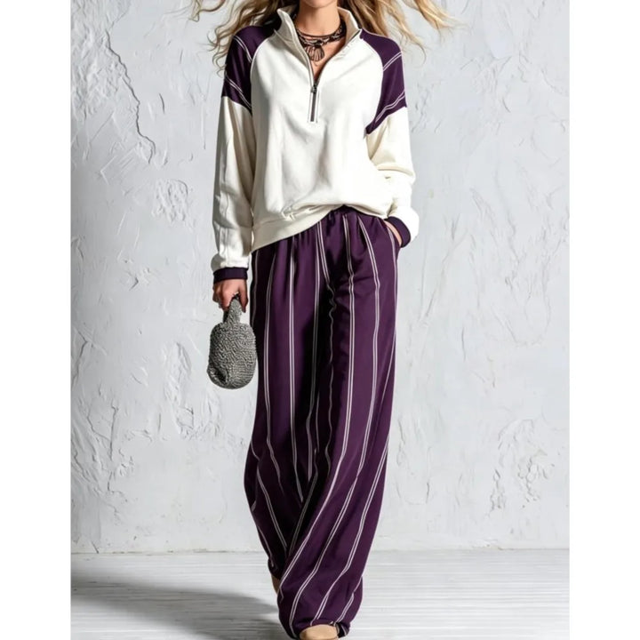 Woman wearing purple striped wide leg pants with cream color block pullover
