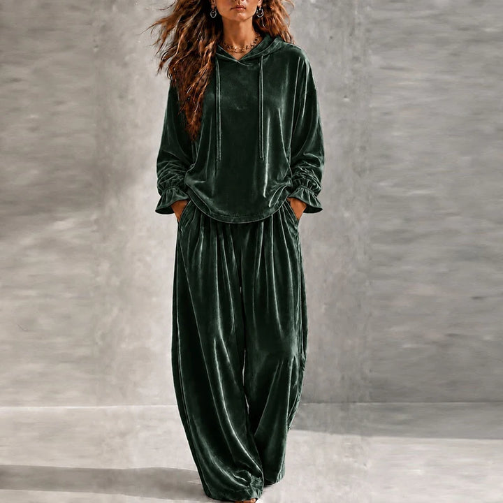 Woman wearing green velvet hooded tracksuit with wide leg pants