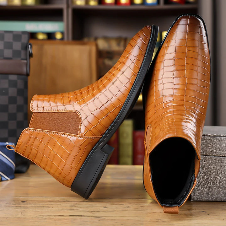 Brown Chelsea boots shown from side and sole angle