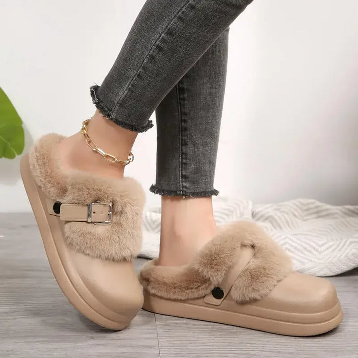 Khaki faux fur platform clog slipper worn on foot, side angle